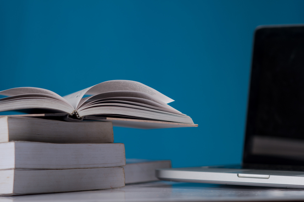 Education Concept, Books and Laptop at Library