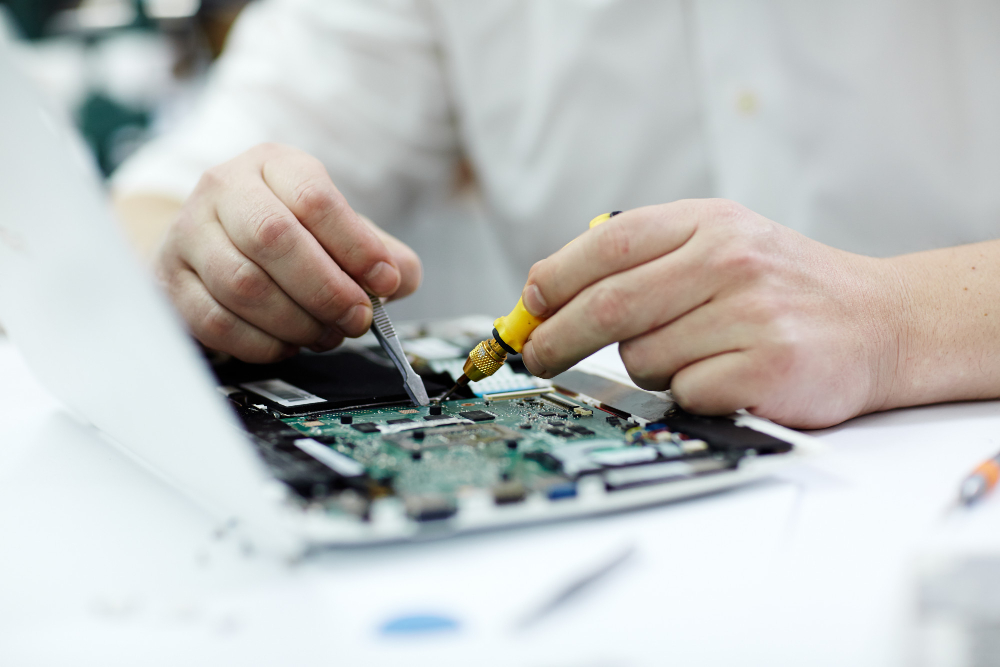 Male hands repairing laptop 