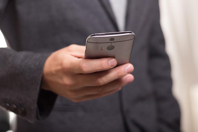 A Man Is Holding a Mobile Phone