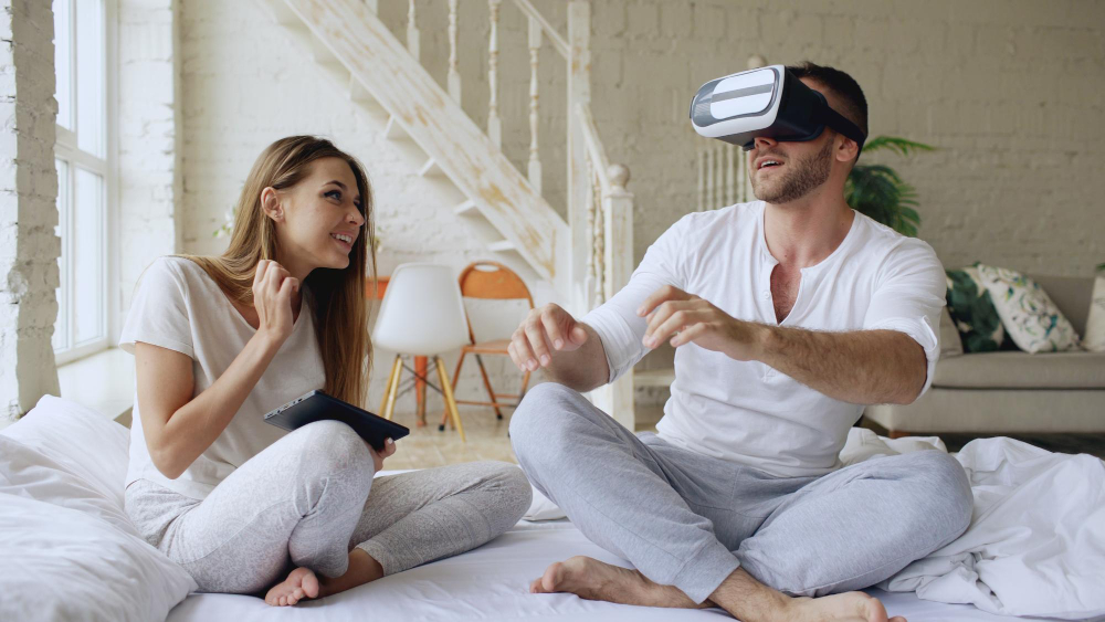 Young Cute Couple Playing 360 vr Video Game While Sitting in Bed at Home