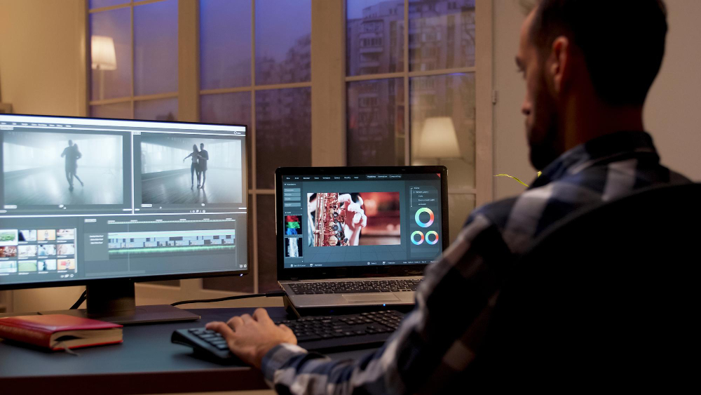 Back View of Content Creator Working in Home Office During Night Time