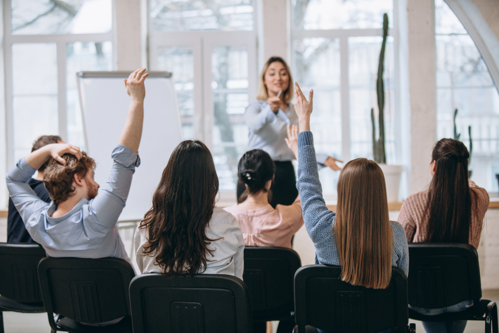 Female Speaker Giving Presentation in Hall at University Workshop