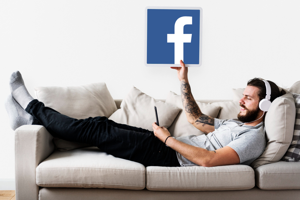 Man Showing a Facebook Icon