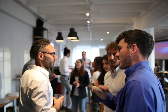 a group of people standing in a room business networking,company presentation,industry connection