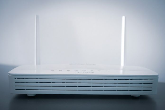 white router on black table wifi router signal smartphone