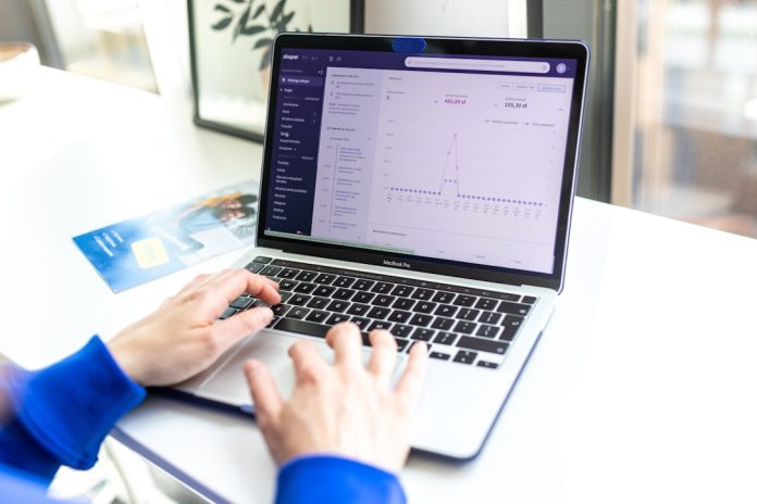 a person typing on a laptop computer on a desk marketing automation dashboard emails leads