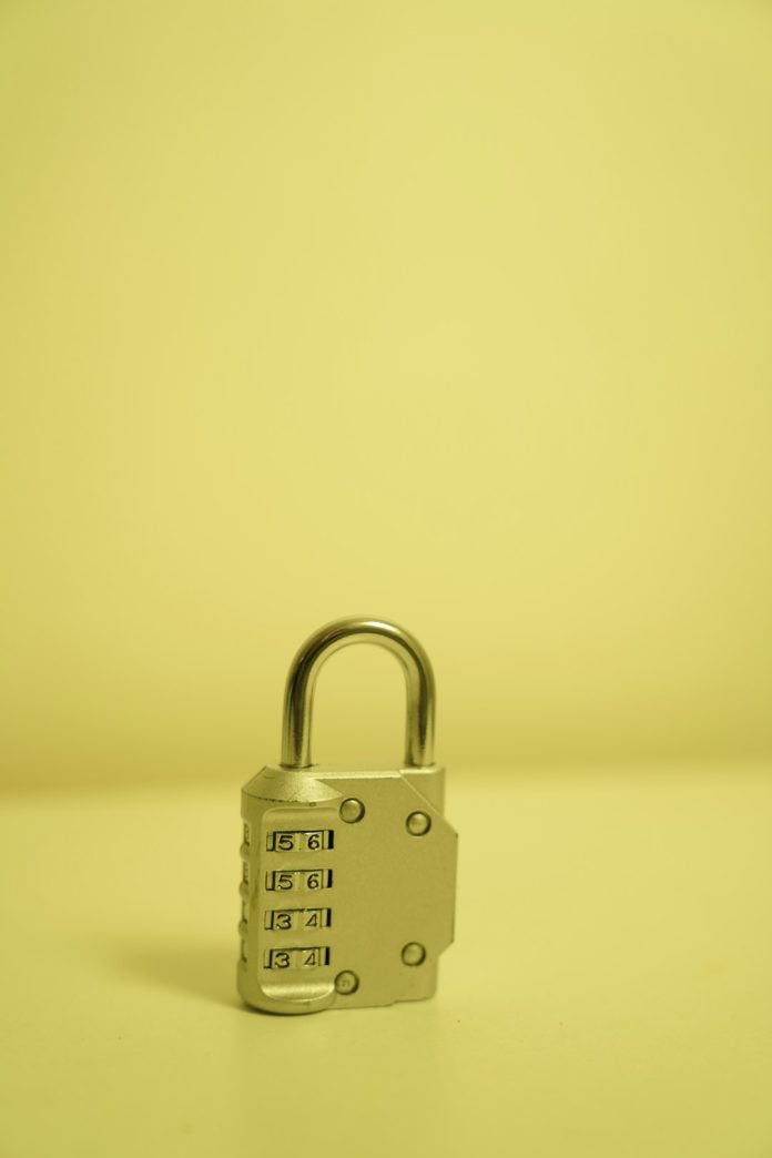 a padlock on a table with a yellow background seo security toolkit wordpress