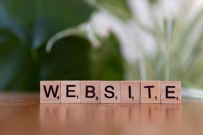 A wooden block spelling the word website on a table domain name brainstorm, website naming, brand idea