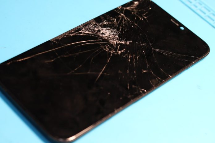 Shattered phone screen: a glaring display of damage. broken phone,error screen,battery warning
