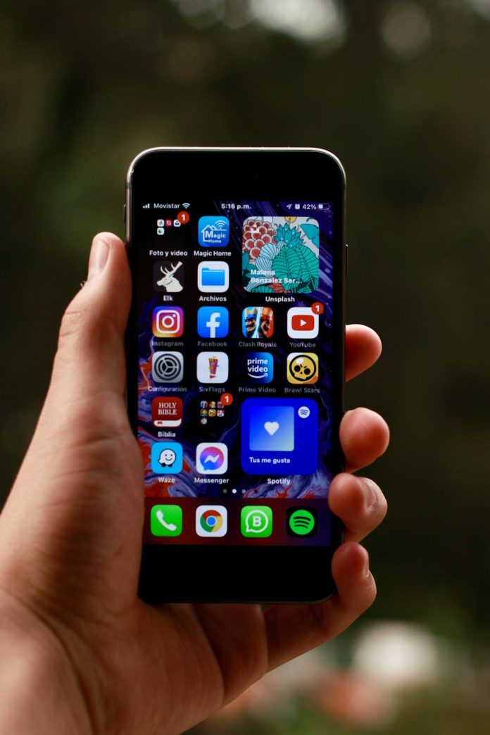 a person holding a smart phone in their hand iphone settings subscriptions menu,cancel app subscription,apple id screen