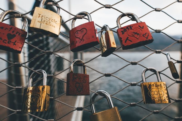 assorted-color padlocks on fence during daytime peer to peer transfer, secure file sharing, direct connection