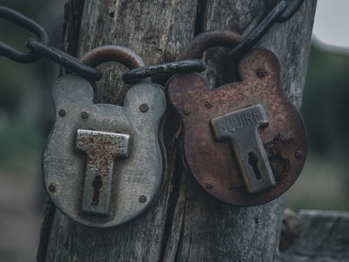 two padlocks are attached to a wooden post peer to peer transfer, secure file sharing, direct connection
