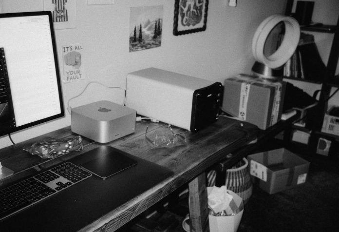 A desk with computers, fan, and storage shelves. hackintosh setup, efi files, macOS installation