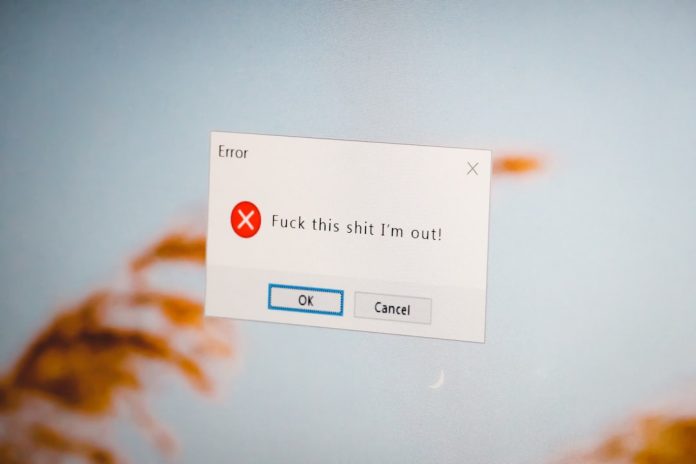 a close up of a computer screen with a sign on it outlook mac error message computer screen user frustrated