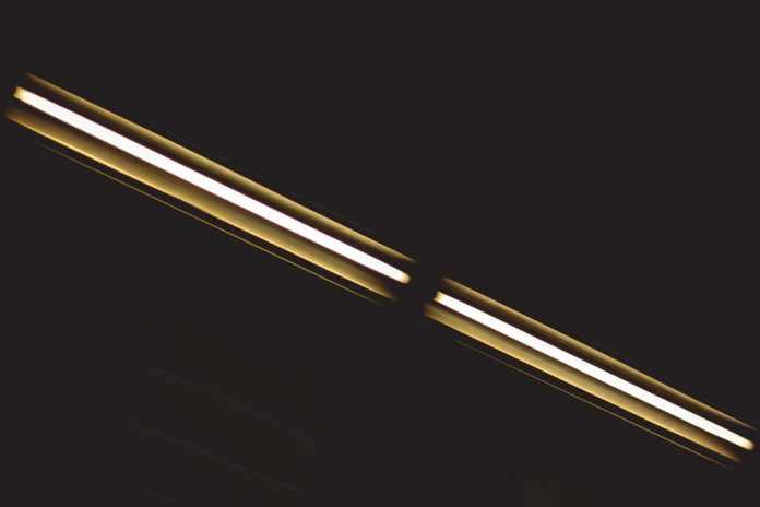 a close up of two lights in the dark cob led strip, seamless light, led comparison