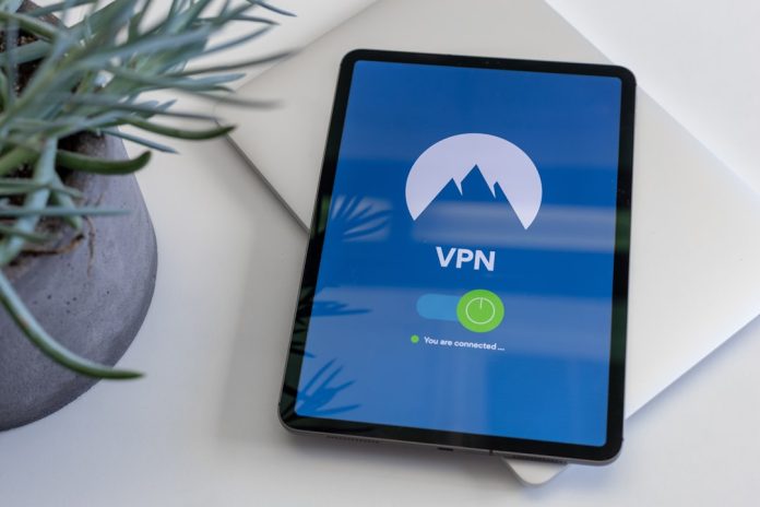 black tablet computer turned on displaying VPN remote work, secure access, vpn login