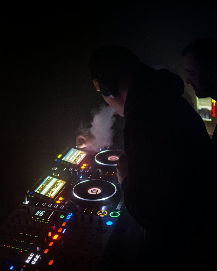 a dj mixing music in a dark room obs interface multiview layout split screen dj performance
