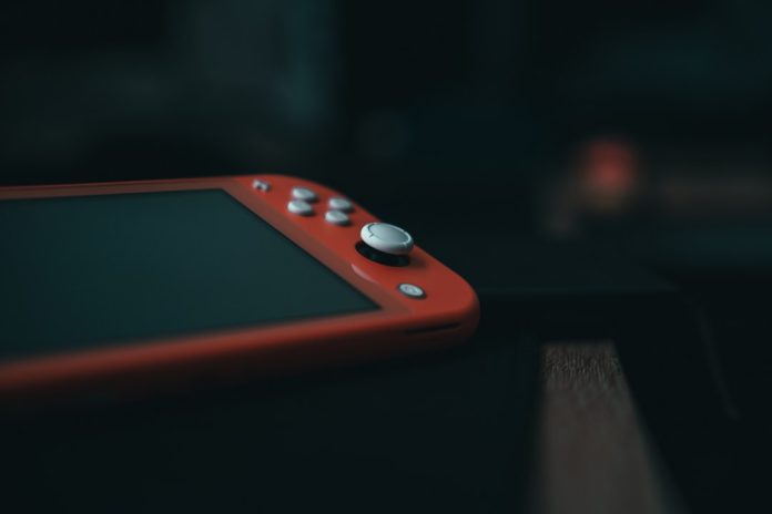 red and black nintendo switch 8bitdo controller pairing mode, led lights flashing, nintendo switch home screen