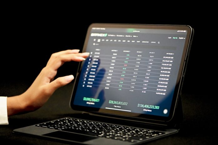 black laptop computer turned on displaying blue screen influencer dashboard analytics screen ecommerce metrics