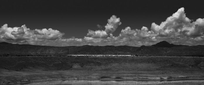 grayscale photo of people on beach under cloudy sky cloud video rendering process, ai processing servers, fast export progress bar