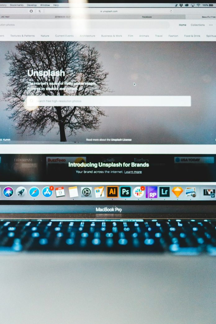 turned-on MacBook Pro website builder dashboard, drag and drop editor, modern website design interface