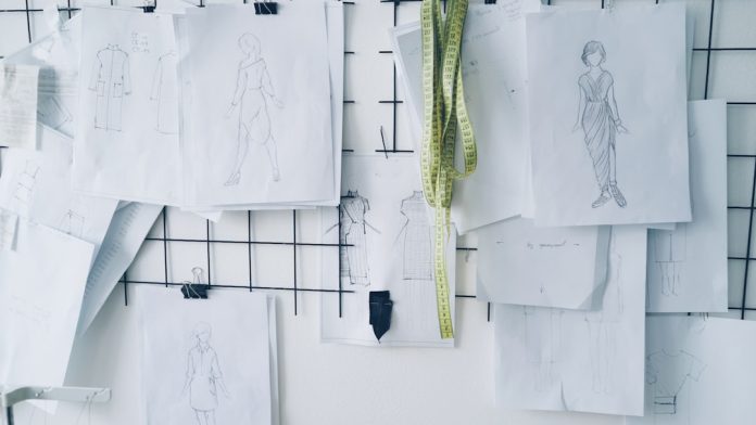 Fashion sketches pinned on a grid board. digital mood board cosplay references, fabric swatches screen, armor sketches layout