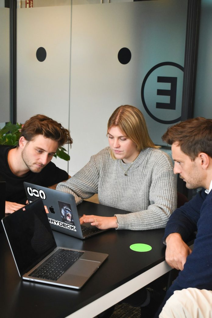 man in gray dress shirt sitting beside woman in green crew neck t-shirt team collaboration office, content editors and developers, workflow planning board