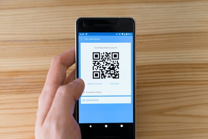 black android smartphone displaying qr code qr code analytics dashboard, campaign reporting, mobile scan