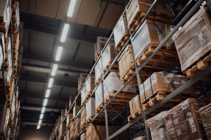 brown cardboard boxes on white metal rack warehouse automation, ecommerce logistics, order fulfillment