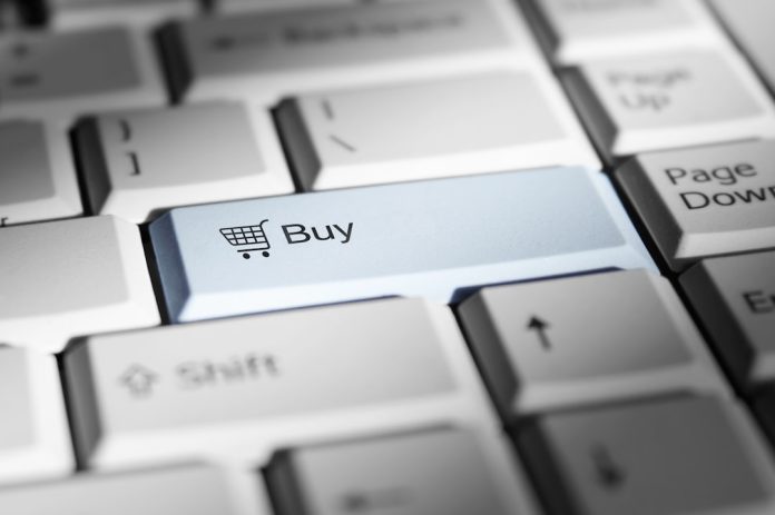 Close-up of a keyboard with a prominent 'buy' button. domain search, coupon code, checkout savings