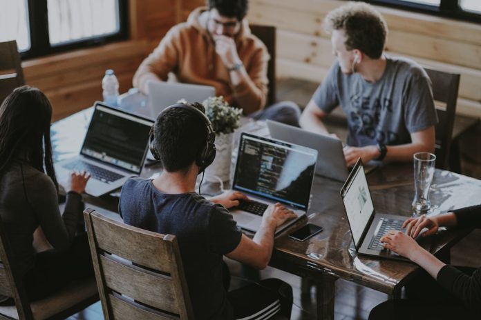 group of people using laptop computer team collaboration mobile publishing workflow
