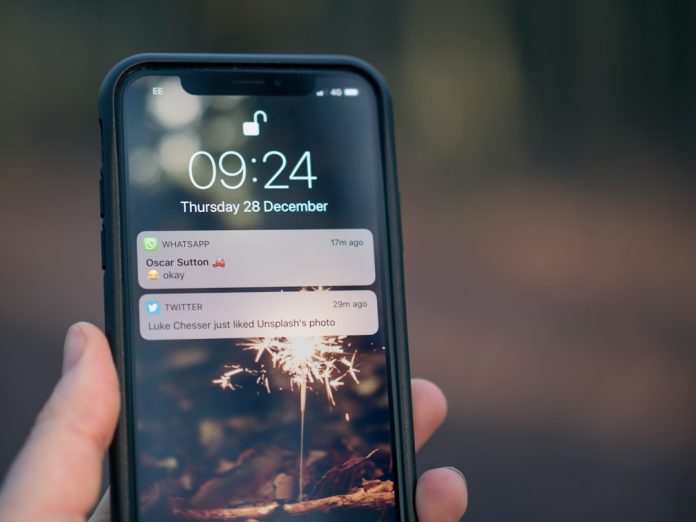 person holding phone mobile push notification smartphone lock screen