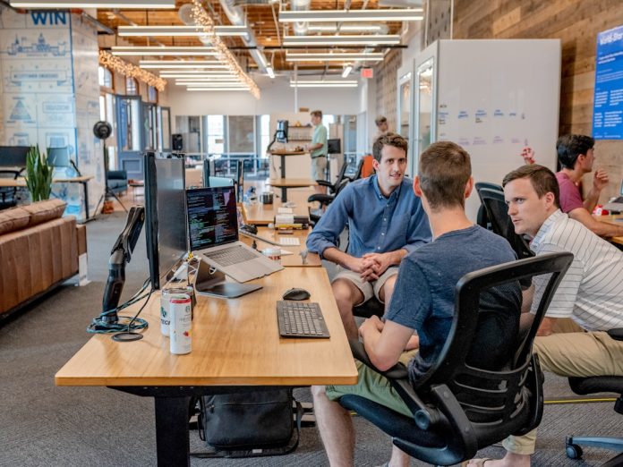 three men sitting on chair beside tables marketing team workflow, automation setup, campaign performance