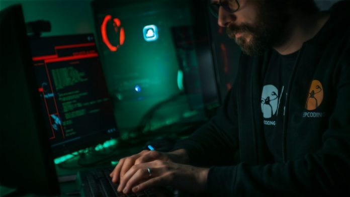 man in black jacket using computer cybersecurity team, server logs, incident response