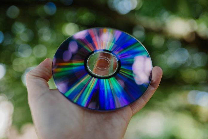 selective focus photography of person holding compact disc dvd disc, vob files, mp4 video, media conversion